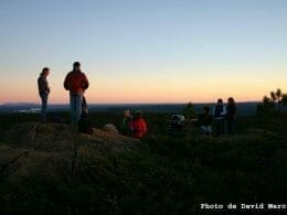 Group of hikers at the summit at sunset