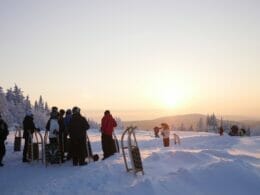 Children and adults at the start of the toboggan run in the Radard ski area