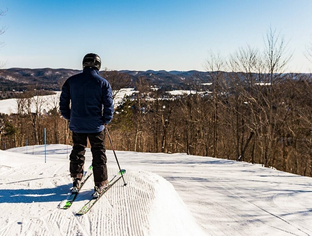 Alpine skier at the summit of Mont Avalanche in St-Adolphe-d'Howard in winter