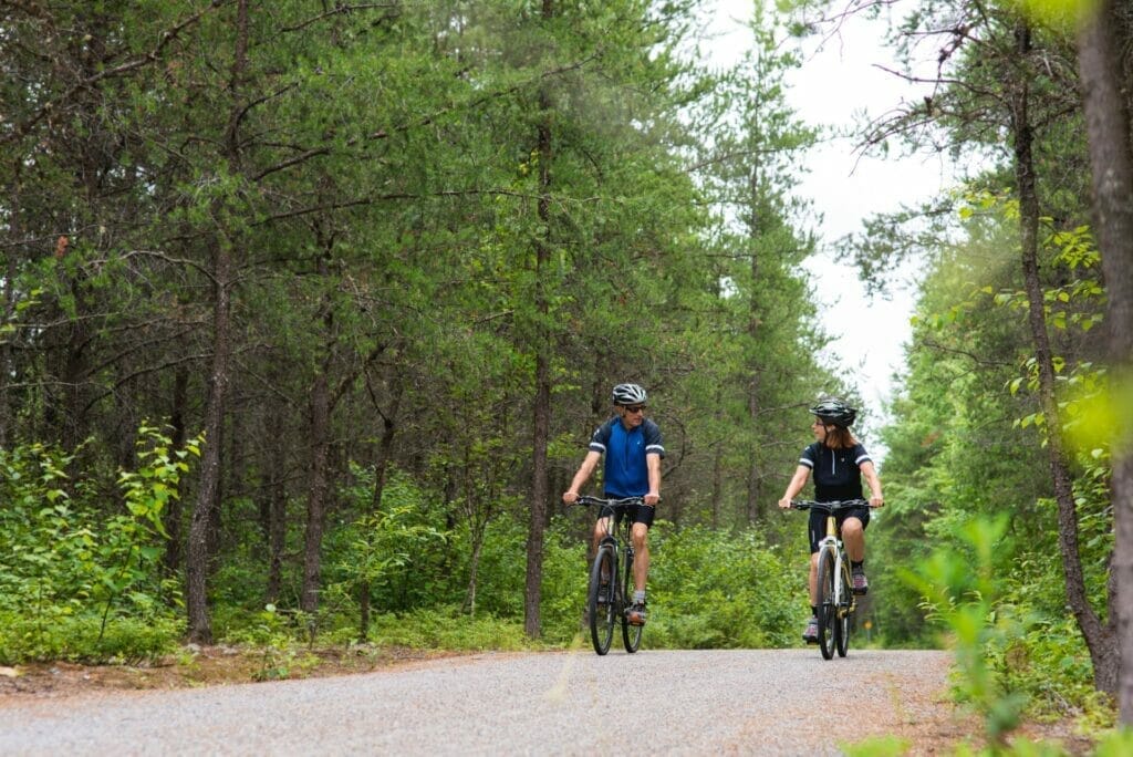 Two cyclists on a stone dust trail in Val d'Or's recreational forest